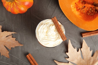 Photo of Flat lay composition with pumpkin spice latte on gray background