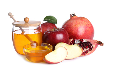 Photo of Honey, apples and pomegranates on white background. Jewish New Year (Rosh Hashanah) holiday