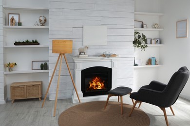 Photo of Stylish living room interior with empty canvas on white wooden wall. Mockup for design