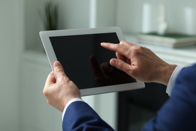 Closeup view of man using new tablet indoors