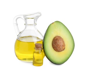 Photo of Oil and fresh cut avocado isolated on white