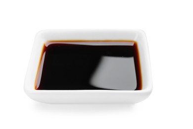 Photo of Bowl of tasty soy sauce isolated on white