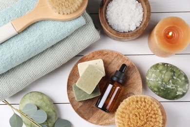 Photo of Flat lay composition with different spa products and burning candle on white wooden table