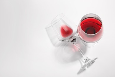 Photo of Tasty red wine in glasses isolated on white