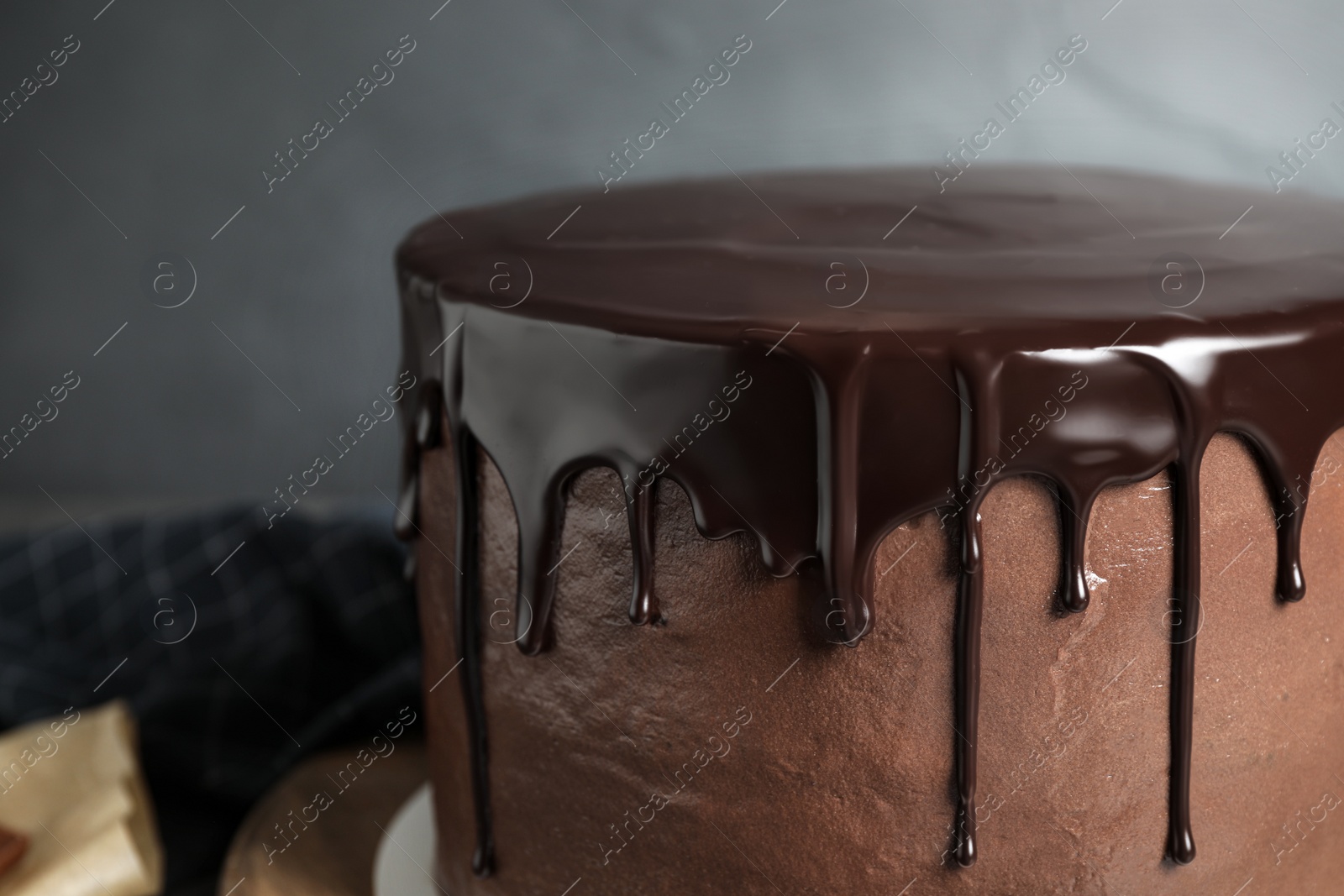 Photo of Freshly made delicious chocolate cake against grey background, closeup