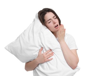 Photo of Sleepy young woman with pillow yawning on white background. Insomnia problem