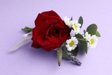 Photo of One small stylish boutonniere on violet background