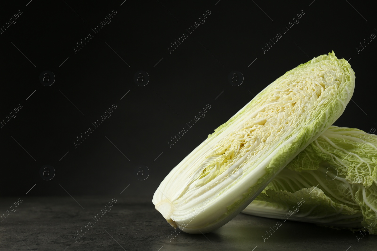 Photo of Fresh ripe Chinese cabbages on grey table, space for text