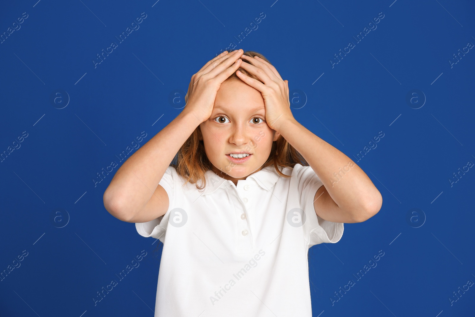 Photo of Portrait of emotional preteen girl on blue background