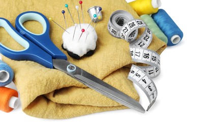 Set of different sewing accessories on white background, closeup