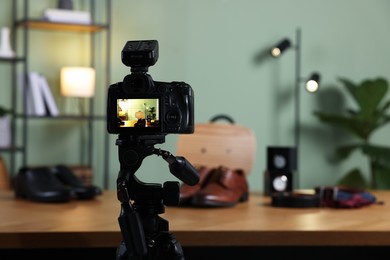 Beauty blogger's workplace. Men's accessories on table indoors, focus on camera