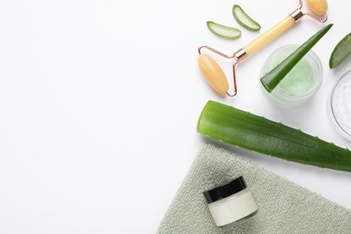 Photo of Flat lay composition with cosmetic products and cut aloe leaves on white background. Space for text