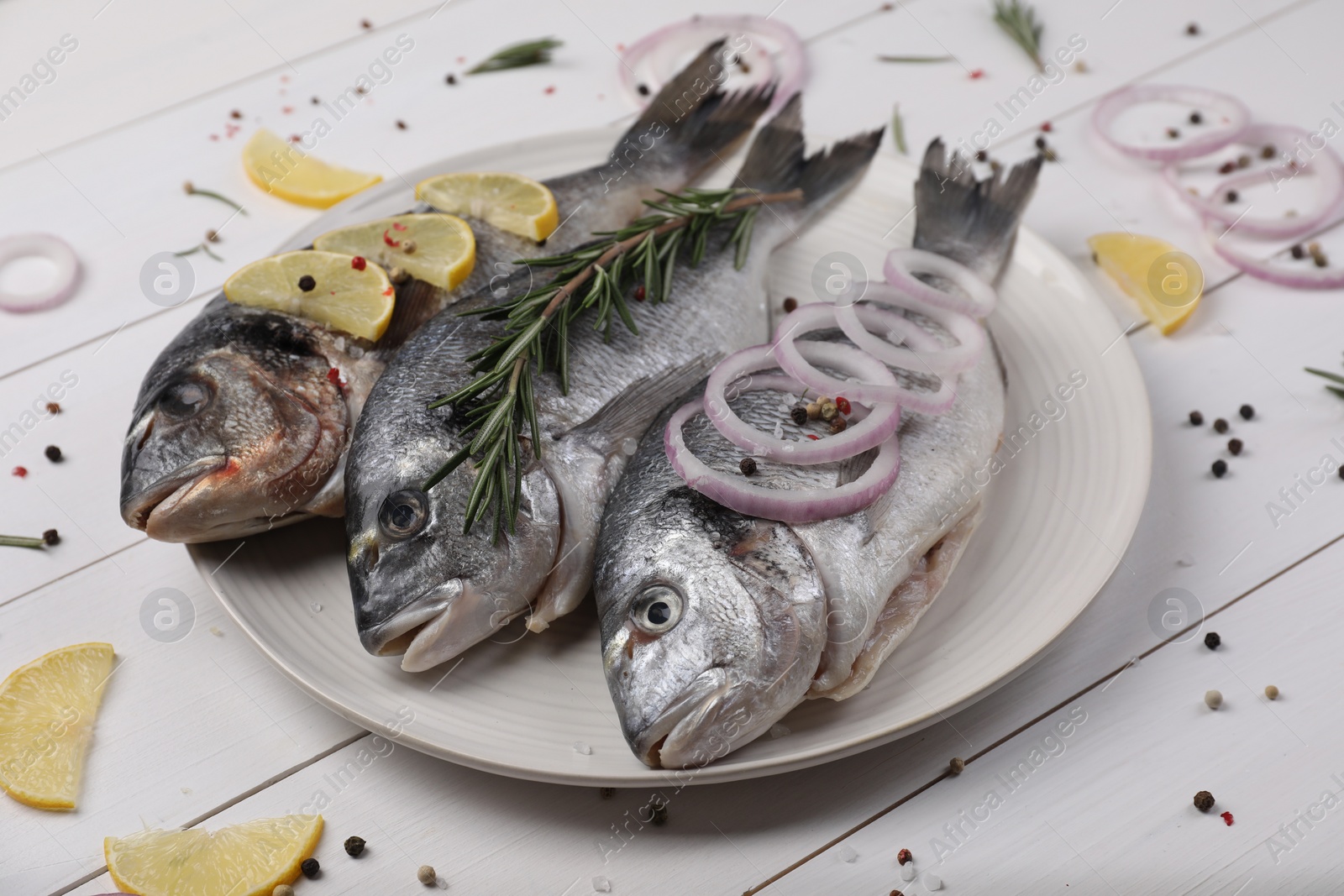 Photo of Composition with raw dorado fish and spices on white wooden table