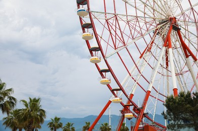Photo of Beautiful large Ferris wheel outdoors. Amusement ride