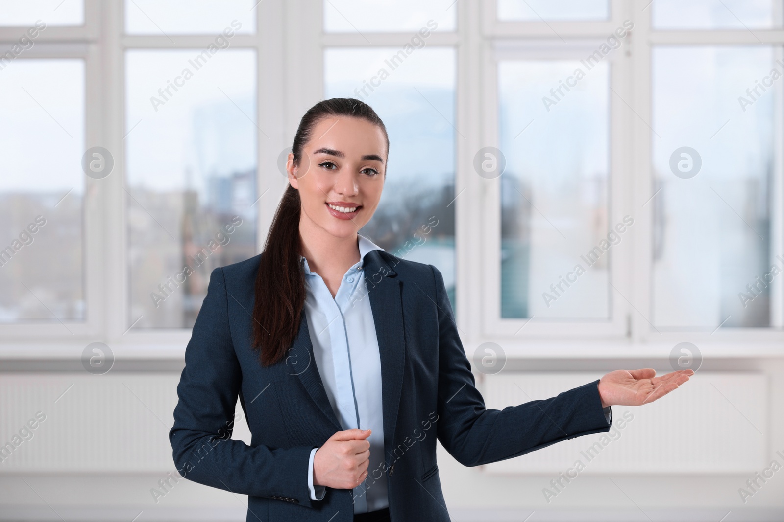 Photo of Happy real estate agent showing new apartment