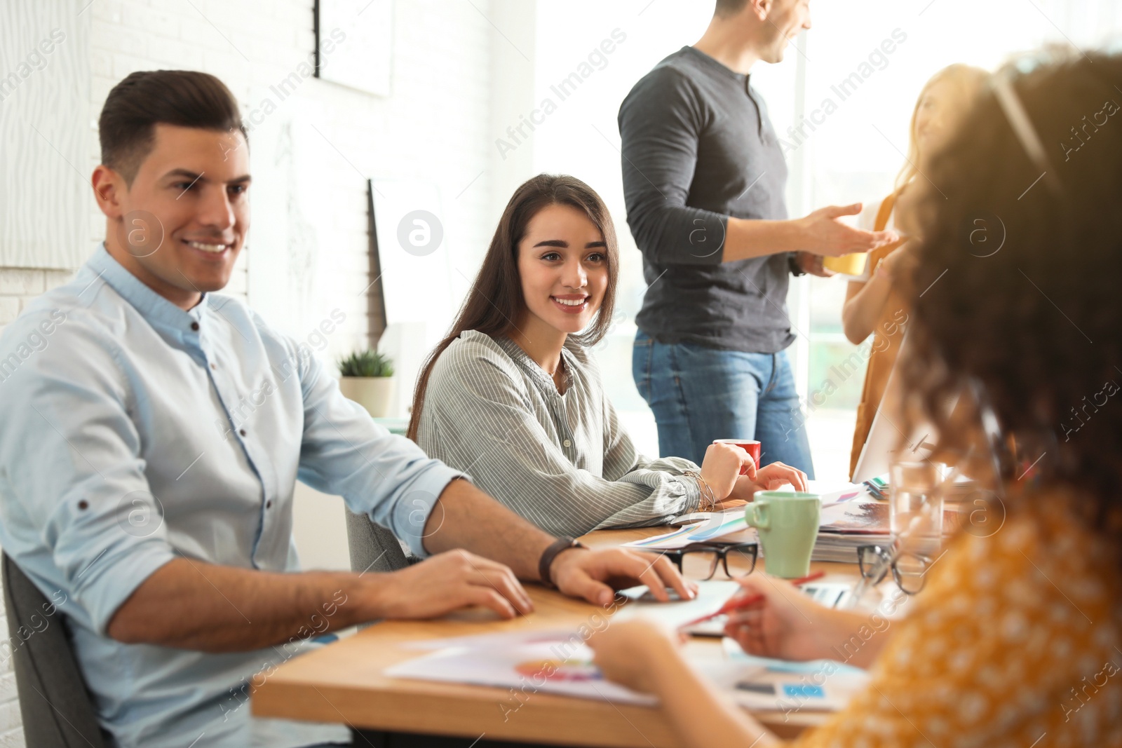 Photo of Team of professional designers working in office