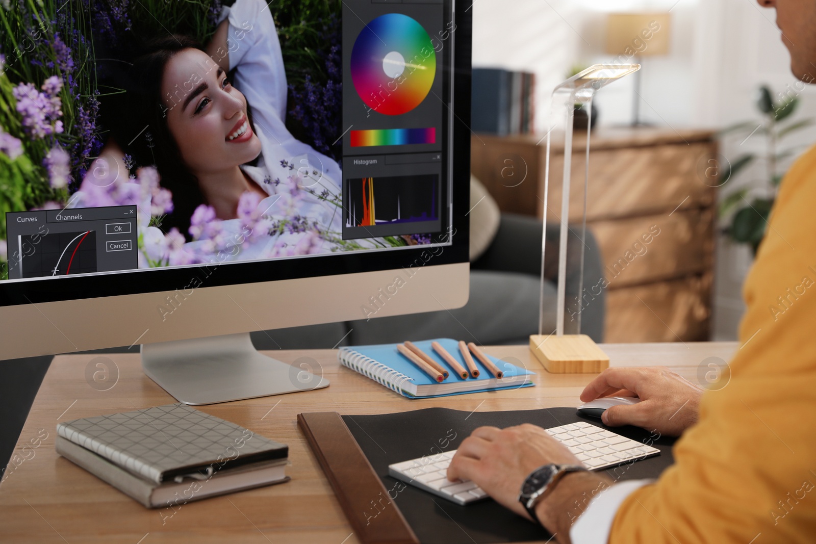 Photo of Professional retoucher working on computer at table, closeup