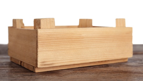 Photo of Empty rustic wooden crate on table against white background