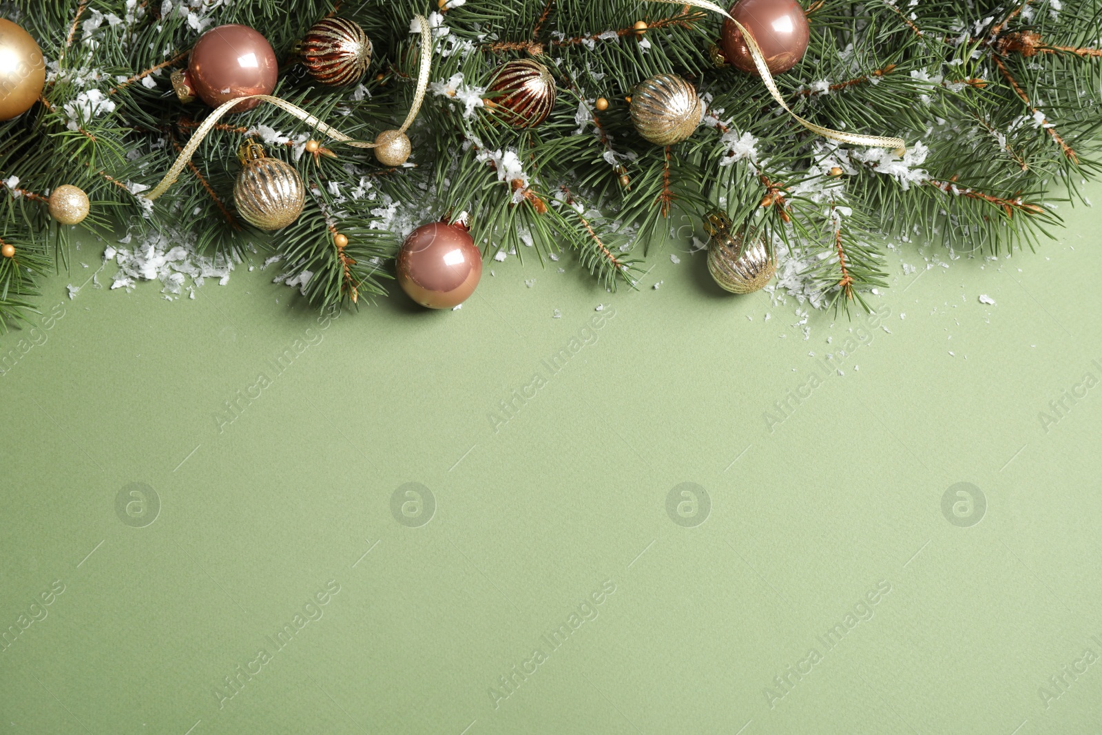 Photo of Fir tree branches with Christmas decoration on green background, flat lay. Space for text