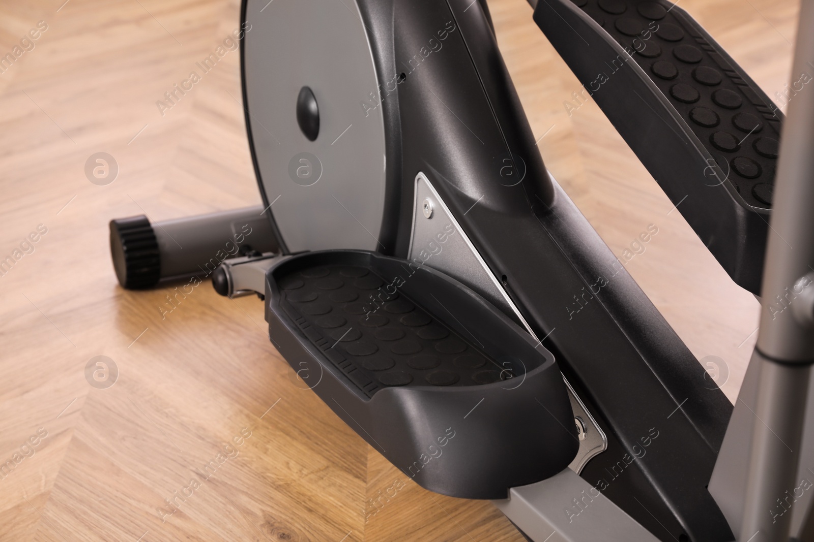 Photo of Modern elliptical machine cross trainer indoors, closeup