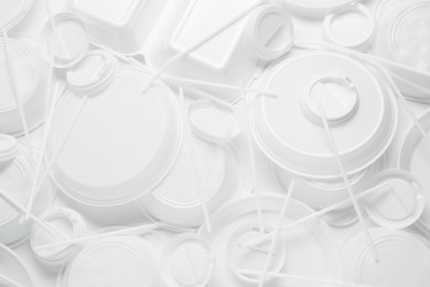 Photo of Different white plastic items as background, closeup