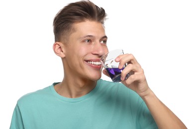 Young man with mouthwash on white background