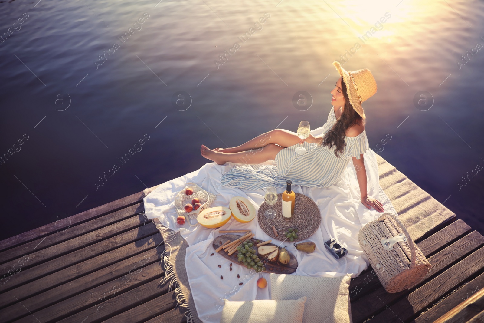 Photo of Young woman spending time on pier at picnic