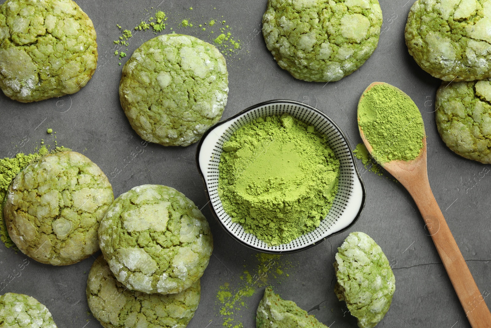 Photo of Tasty matcha cookies and powder on grey table, flat lay
