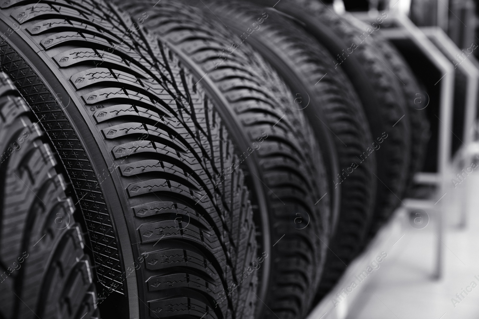 Photo of Car tires on rack in auto store, closeup