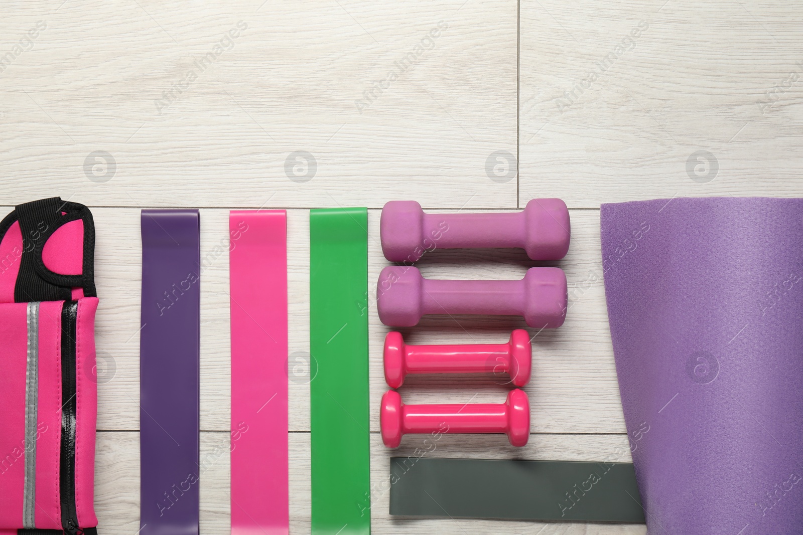 Photo of Different sports equipment on white wooden table, flat lay. Space for text