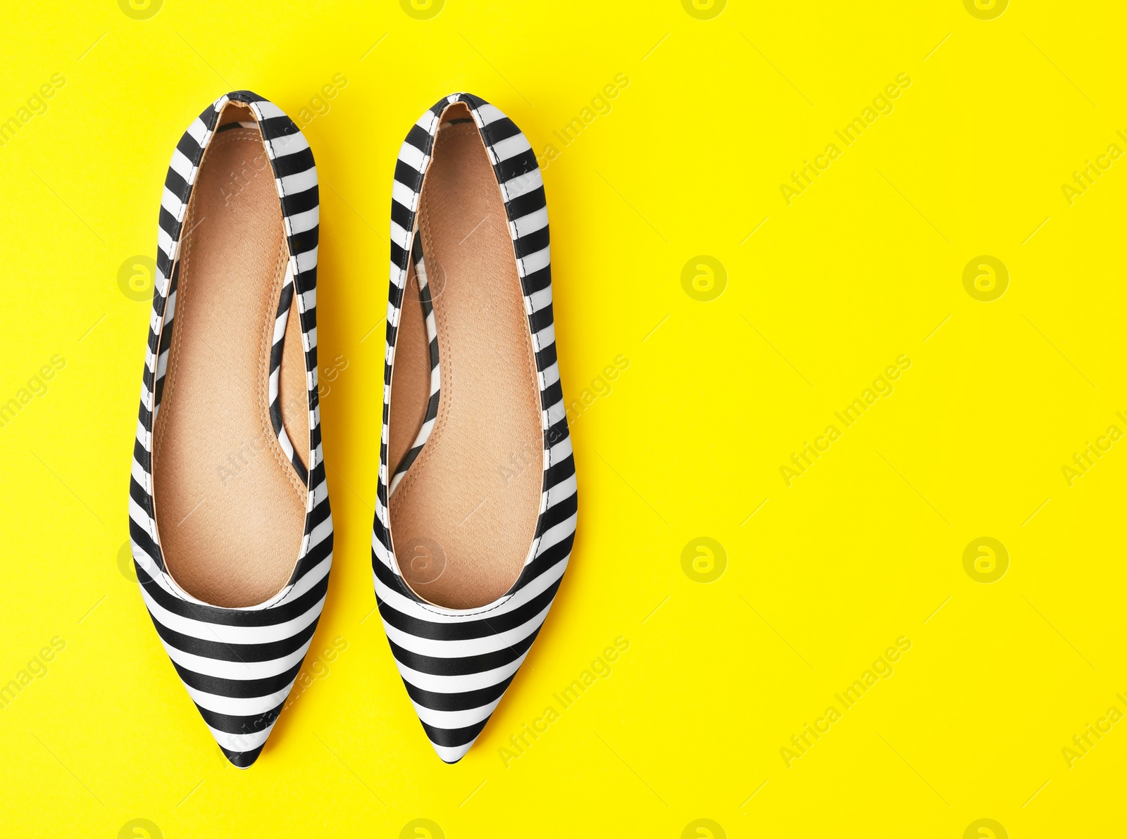 Photo of Pair of female shoes on color background, top view