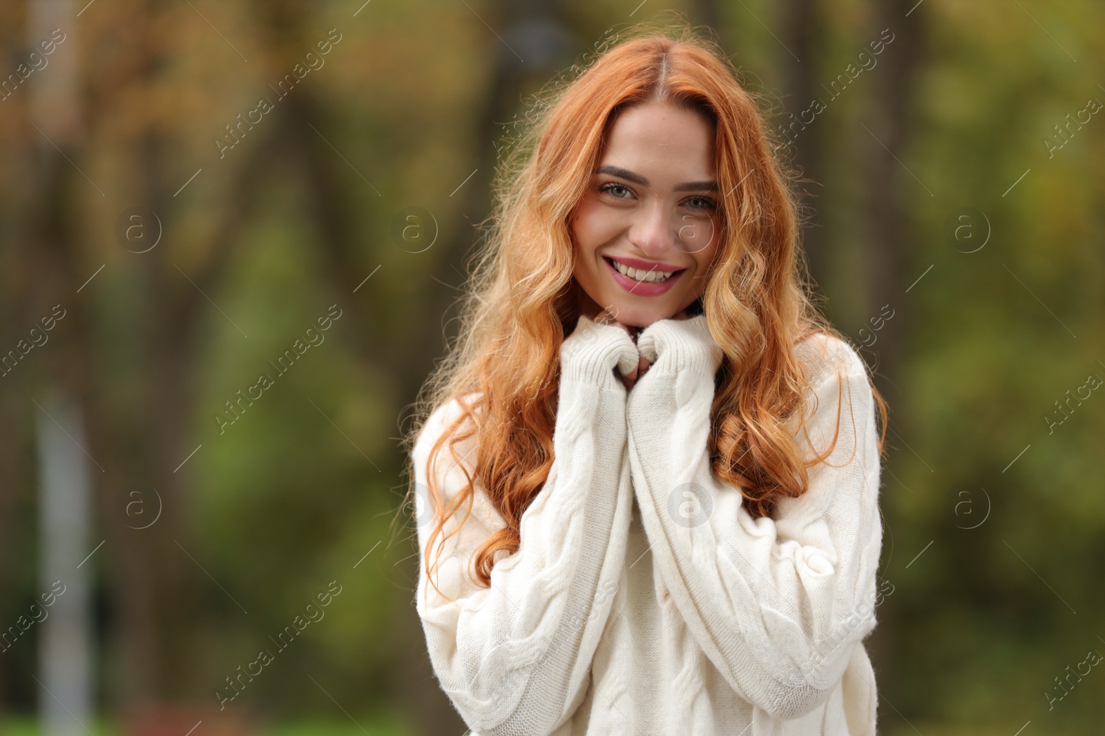 Photo of Autumn vibes. Portrait of smiling woman outdoors. Space for text