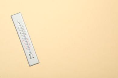 Photo of Weather thermometer on beige background, top view. Space for text