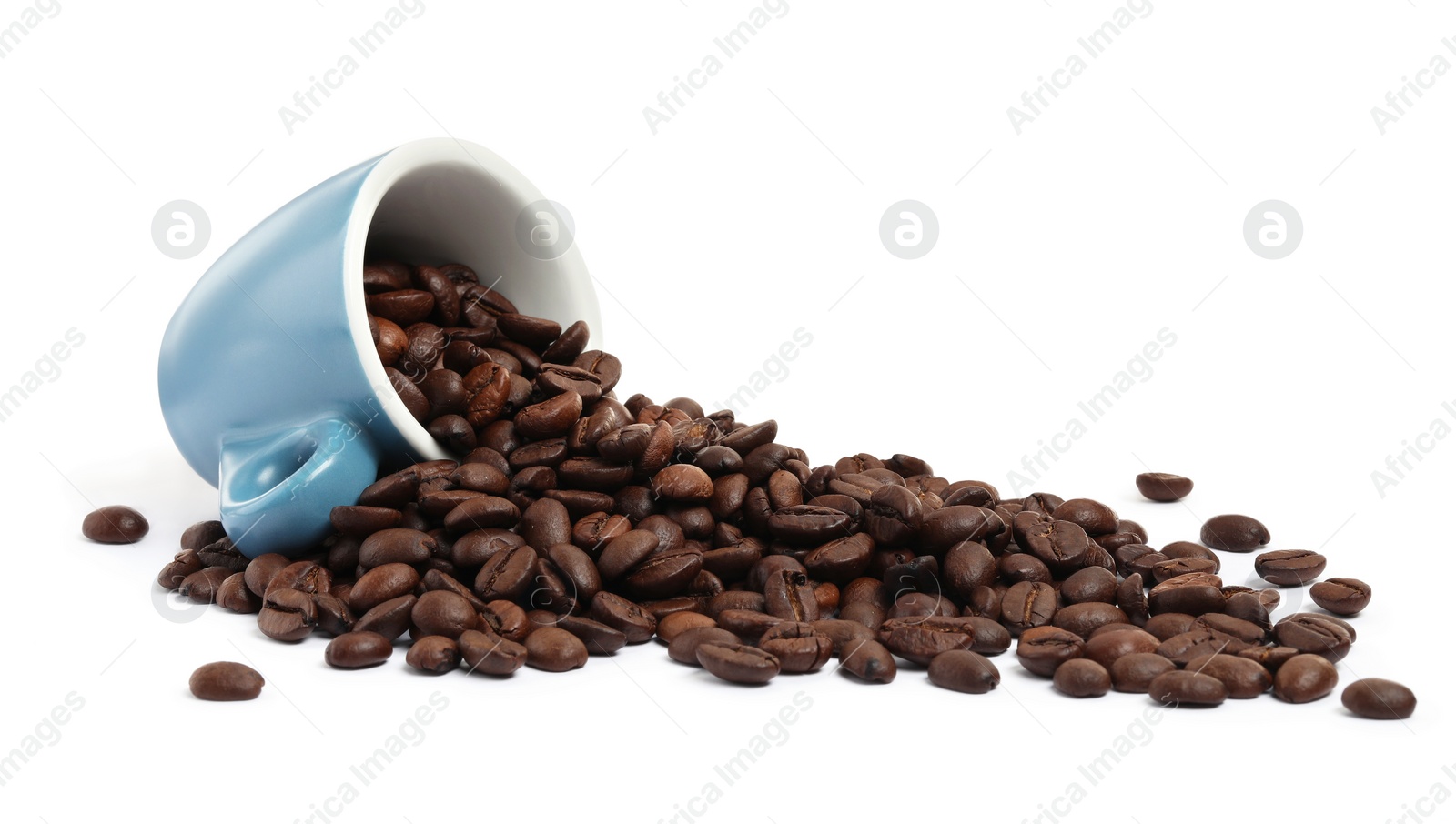 Photo of Coffee beans and overturned light blue cup isolated on white