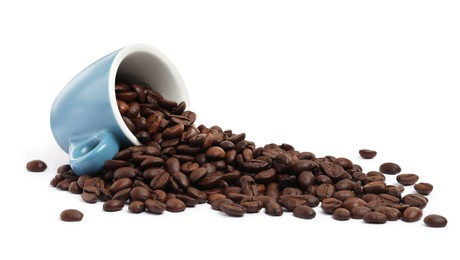 Photo of Coffee beans and overturned light blue cup isolated on white