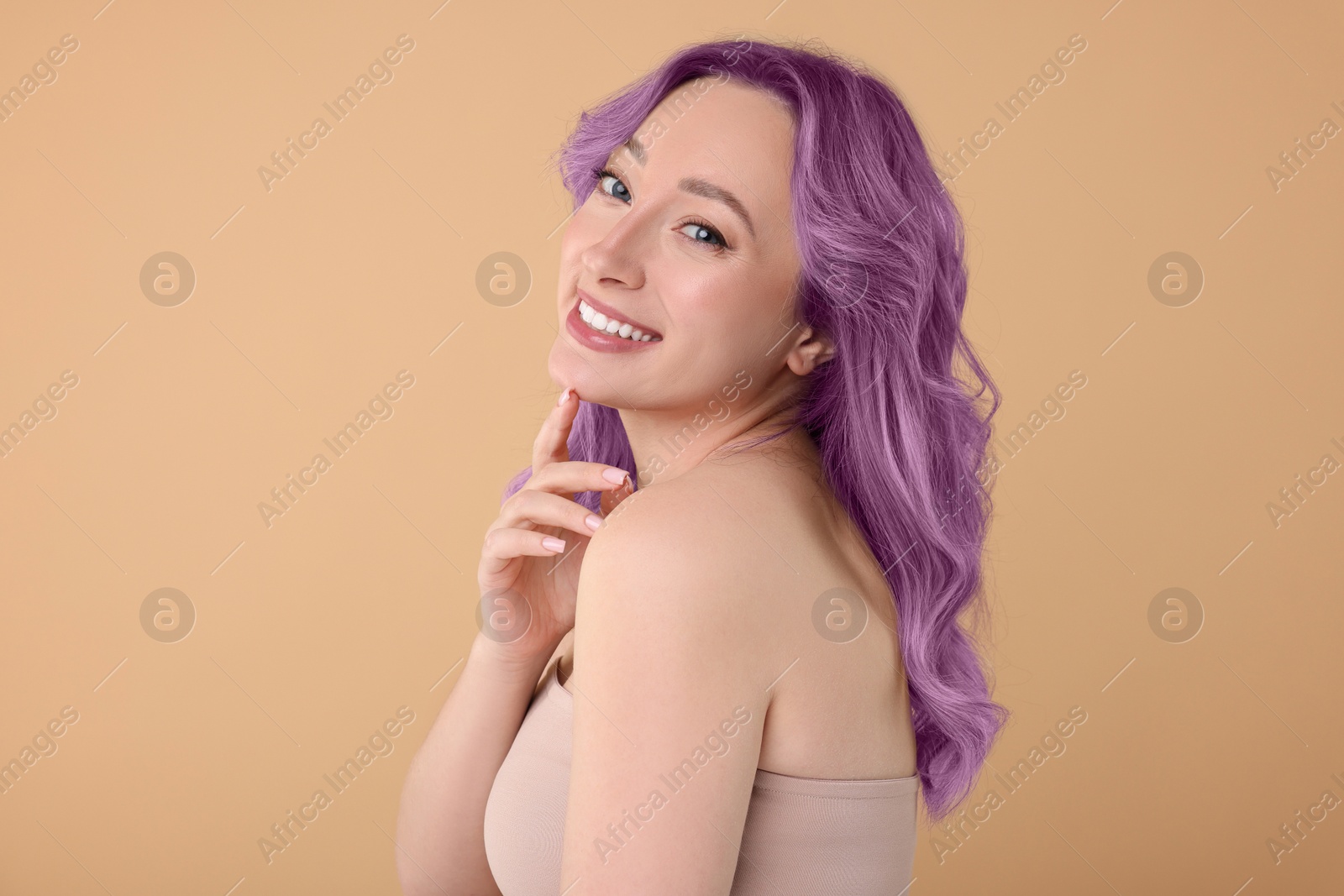 Image of Trendy hairstyle. Young woman with colorful dyed hair on dark beige background