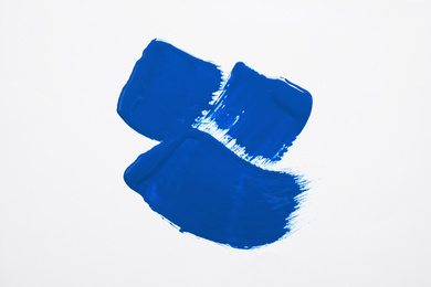 Paint strokes on white background background, top view. Color of the year 2020 (Classic blue)