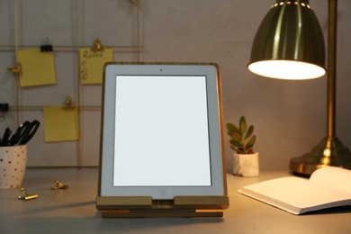 Modern tablet with blank screen on table