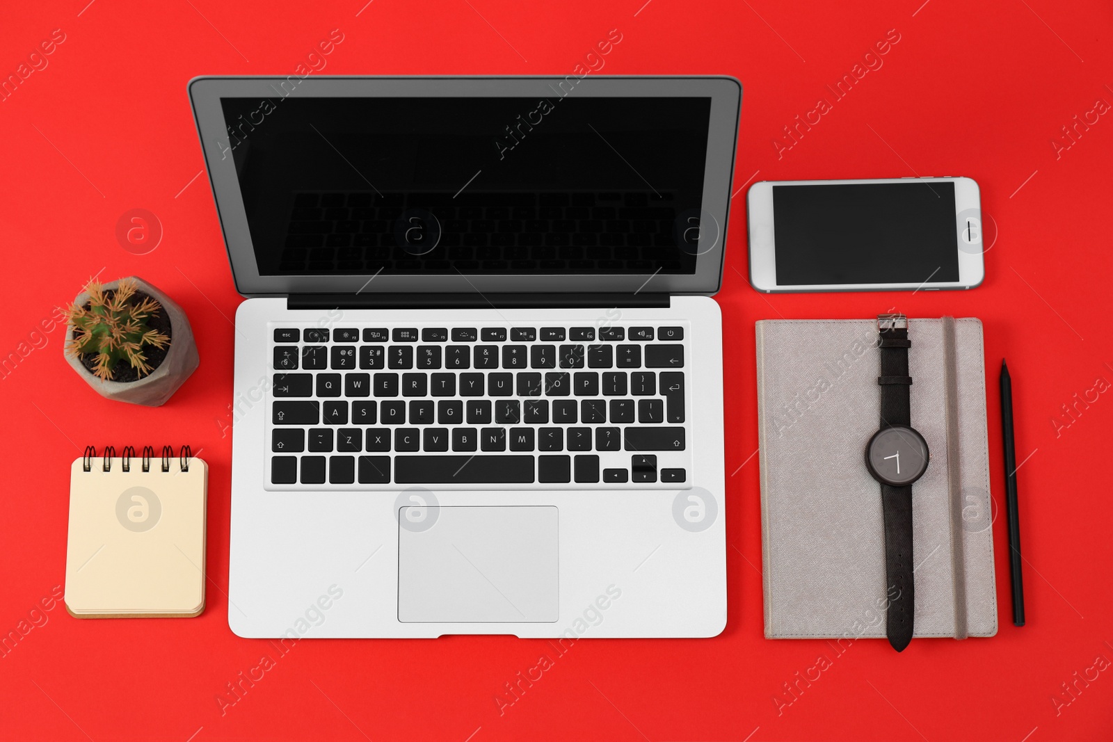 Photo of Flat lay composition with modern devices and office tools on red background