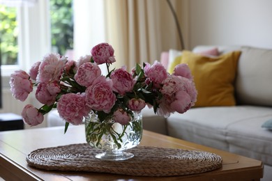 Beautiful pink peonies in vase on table at home. Interior design