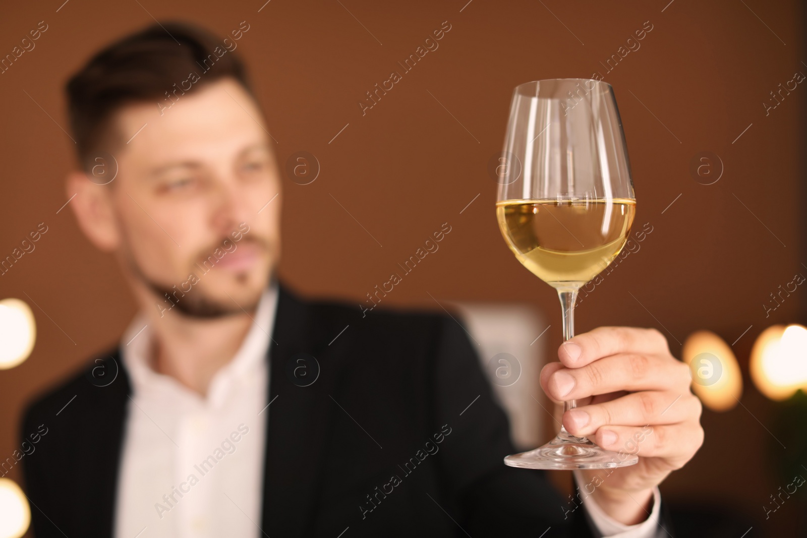 Photo of Young man with glass of wine indoors