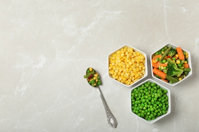 Flat lay composition with frozen vegetables on light background