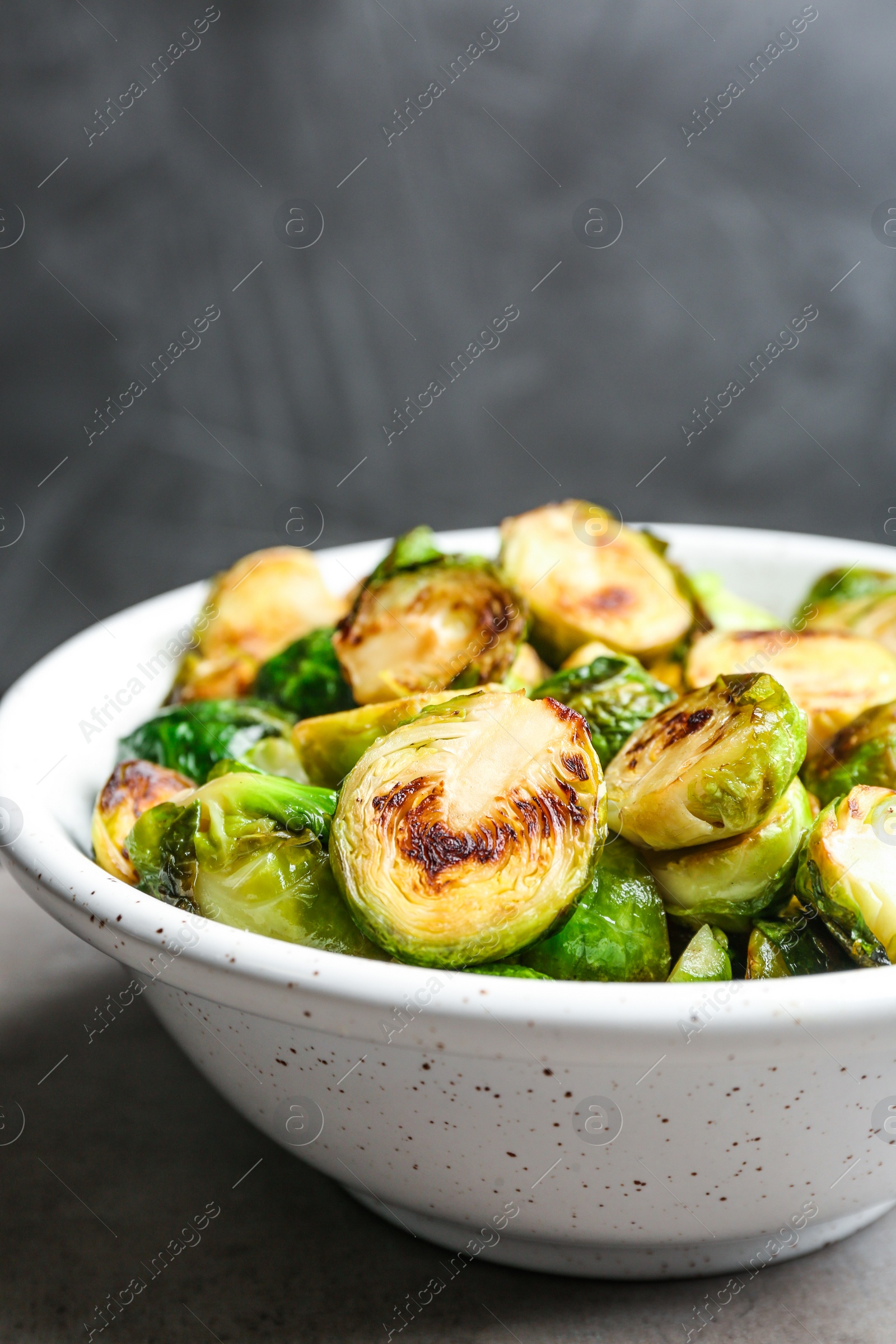 Photo of Roasted Brussels sprouts in bowl on grey table