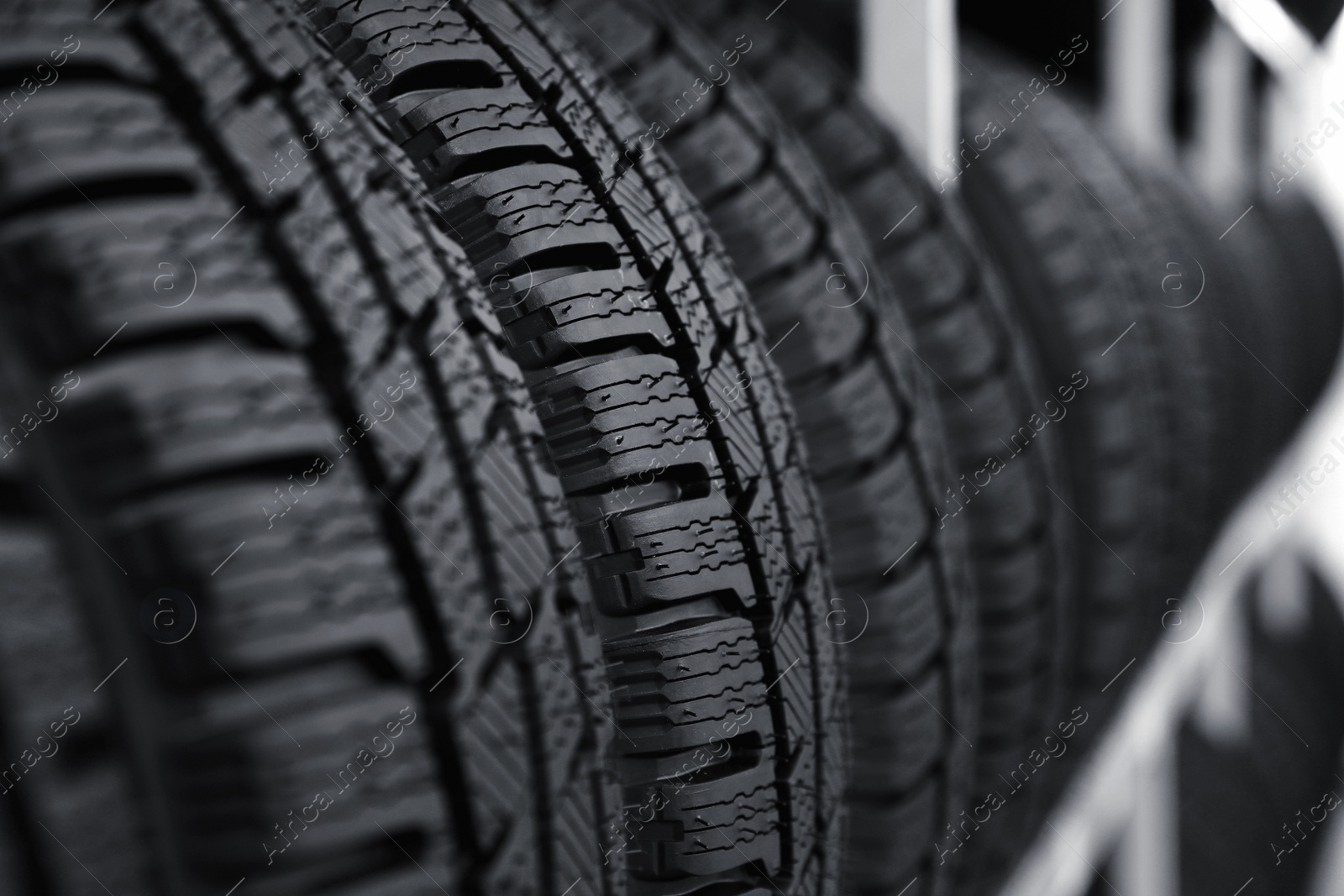 Photo of Car tires on rack in auto store, closeup