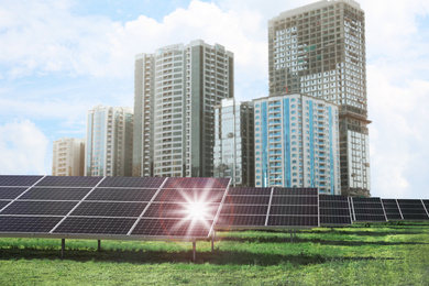 Image of Cityscape and solar panels installed outdoors. Alternative energy source