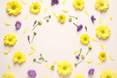 Photo of Beautiful chamomile flowers on beige background, flat lay. Space for text