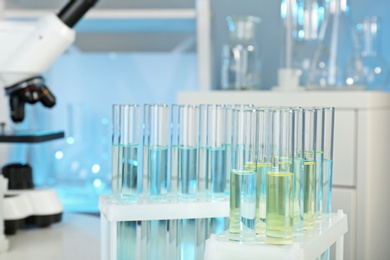 Photo of Rack with test tubes in laboratory, closeup. Chemical analysis