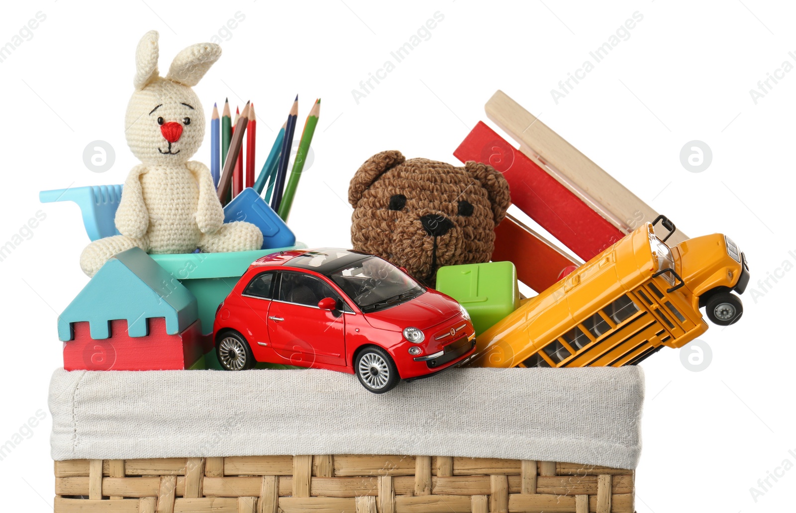 Photo of Wicker basket with different children's toys isolated on white