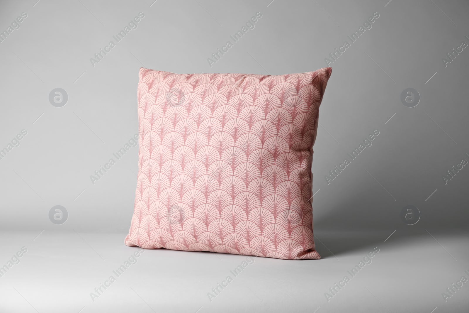 Photo of Soft decorative pillow on light background