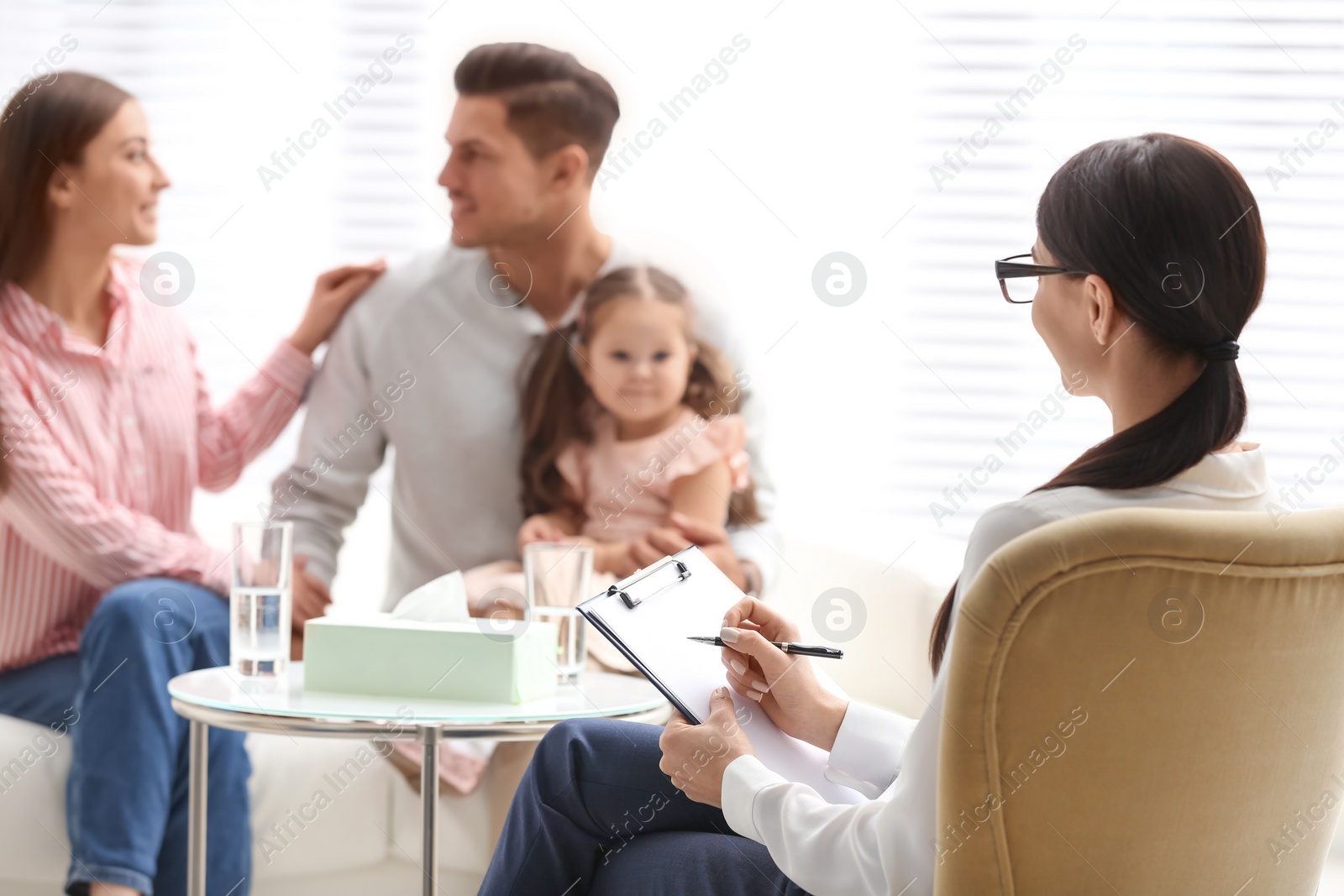 Photo of Professional psychologist working with family in office